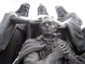 Artist's depiction of Peter James and John laying their hands upon the head of Joseph Smith